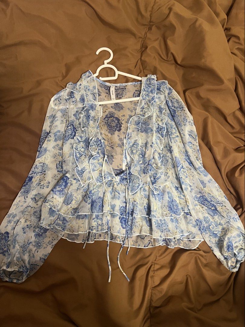 Mango Blue Floral Ruffle Blouse Top (Category: Blouses) located in Muntinlupa City. Submitted by yynsa (Listing ID 1469091657, Image 3). Description: Bought last year Blue floral ruffle blouse with tie front.