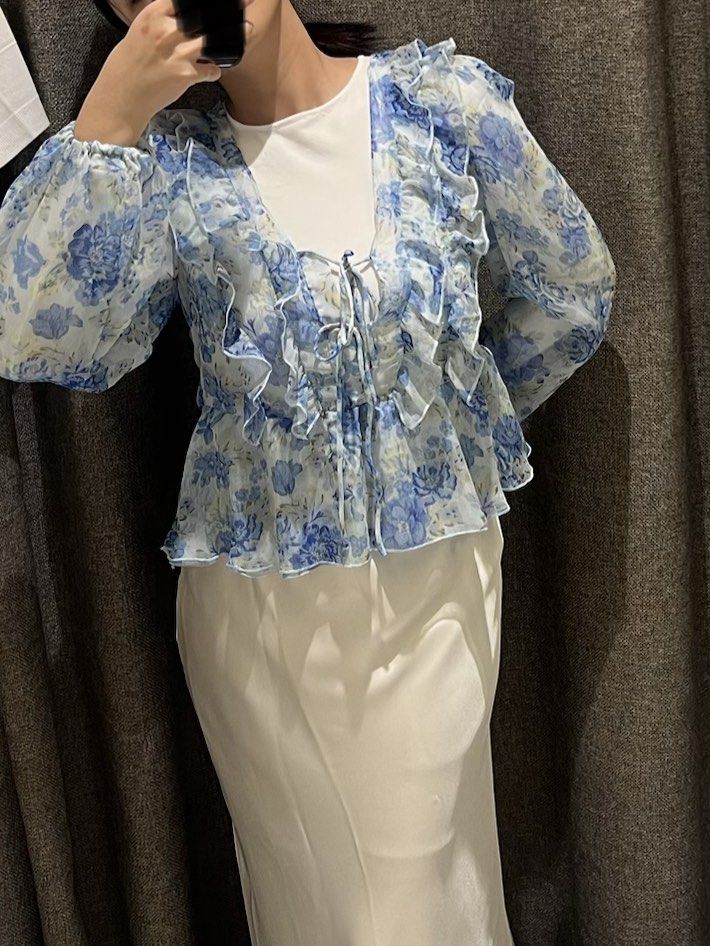 Mango Blue Floral Ruffle Blouse Top (Category: Blouses) located in Muntinlupa City. Submitted by yynsa (Listing ID 1469091657, Image 2). Description: Bought last year Blue floral ruffle blouse with tie front.