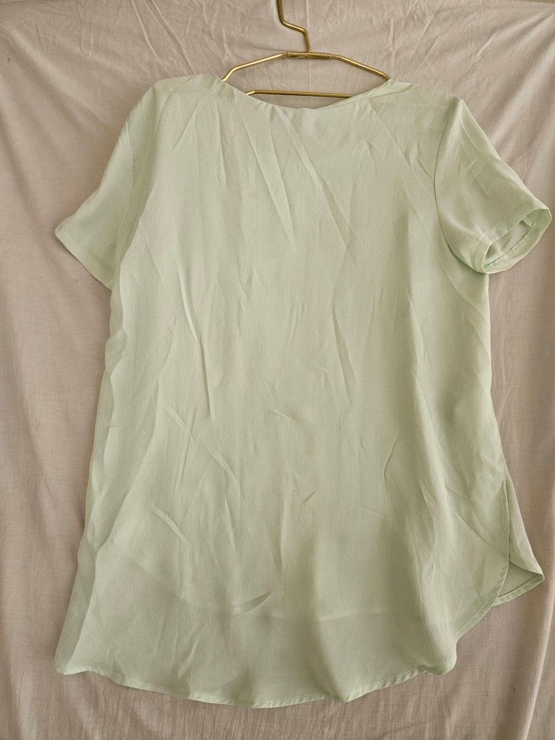 Mango Green Short Sleeve Blouse (Category: Blouses) located in Quezon City. Submitted by _pcloset (Listing ID 1469005363, Image 3). Description: - Brand: Mango - Color: Mint Green - Fit: Relaxed fit with a scoop neckline and curved hem - Fabric: Soft, lightweight material - Style: Versatile for casual days or office wear.