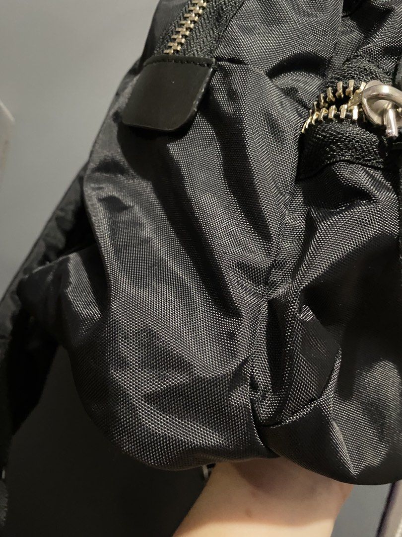 Marc Jacobs Nylon Backpack Black (Category: Luxury Bags & Wallets) located in Batangas. Submitted by bagstolove3.0 (Listing ID 1469107112, Image 3). Description: - Brand: Marc Jacobs - Color: Classic Black - Material: Durable woven nylon with sturdy metal hardware - Pockets: 2 front utility zippered pockets - Details: Signature branded leather patch and metal plaque - Straps: Adjustable shoulder straps for comfort - Condition: Clean interior lini