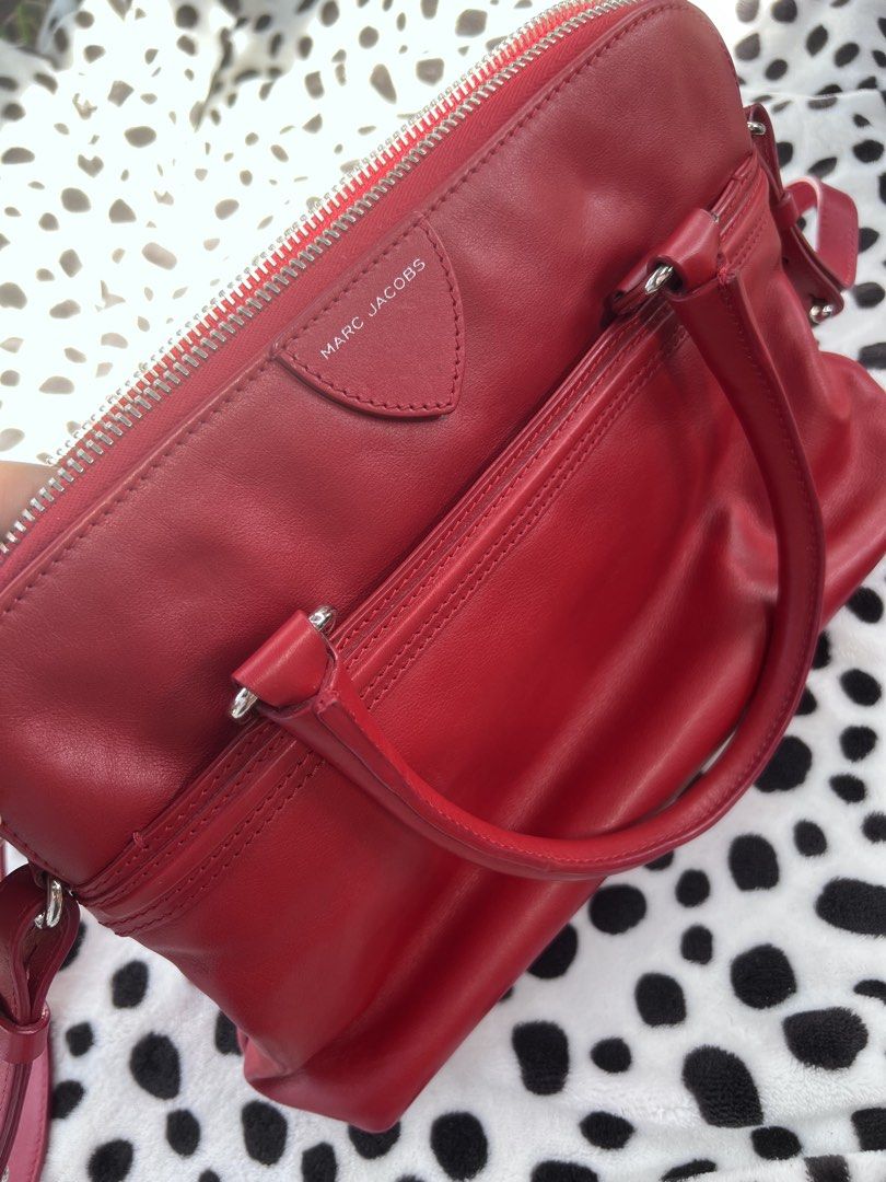 Marc Jacobs Red Leather Satchel Handbag (Category: Luxury Bags & Wallets) located in Rizal. Submitted by imallari88 (Listing ID 1469009948, Image 1). Description: - Brand: Marc Jacobs - Style: Leather Satchel - Color: Bright red with silver hardware - Carry options: Dual top handles and adjustable/removable strap - Pockets: Front exterior zip pocket, interior zip pocket, and two slip pockets Bonus: 5days lang ginamit sa Japan. Inikot lang from Fu