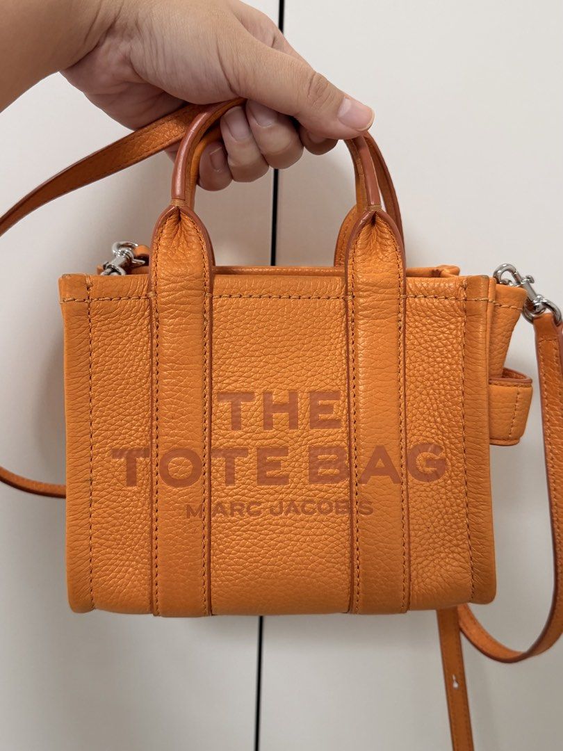 Marc Jacobs Scorched Micro Leather Bag (Category: Luxury Bags & Wallets) located in Cebu City. Submitted by yllxco (Listing ID 1469155249, Image 1). Description: Marc Jacobs Scorched Micro Leather Bag 🧡 Color: Orange Preloved bag with visible signs of use. Please check the photos carefully for the actual condition and details. Details: • Brand: Marc Jacobs • Model: Scorched Micro Leather Bag • Color: Orange • Material: 100% Calfskin Leather • Si
