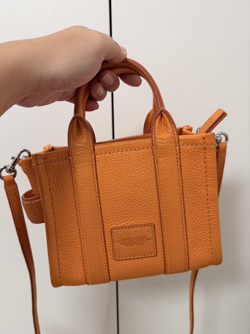 Marc Jacobs Scorched Micro Leather Bag (Category: Luxury Bags & Wallets) located in Cebu City. Submitted by yllxco (Listing ID 1469155249, Image 2). Description: Marc Jacobs Scorched Micro Leather Bag 🧡 Color: Orange Preloved bag with visible signs of use. Please check the photos carefully for the actual condition and details. Details: • Brand: Marc Jacobs • Model: Scorched Micro Leather Bag • Color: Orange • Material: 100% Calfskin Leather • Si