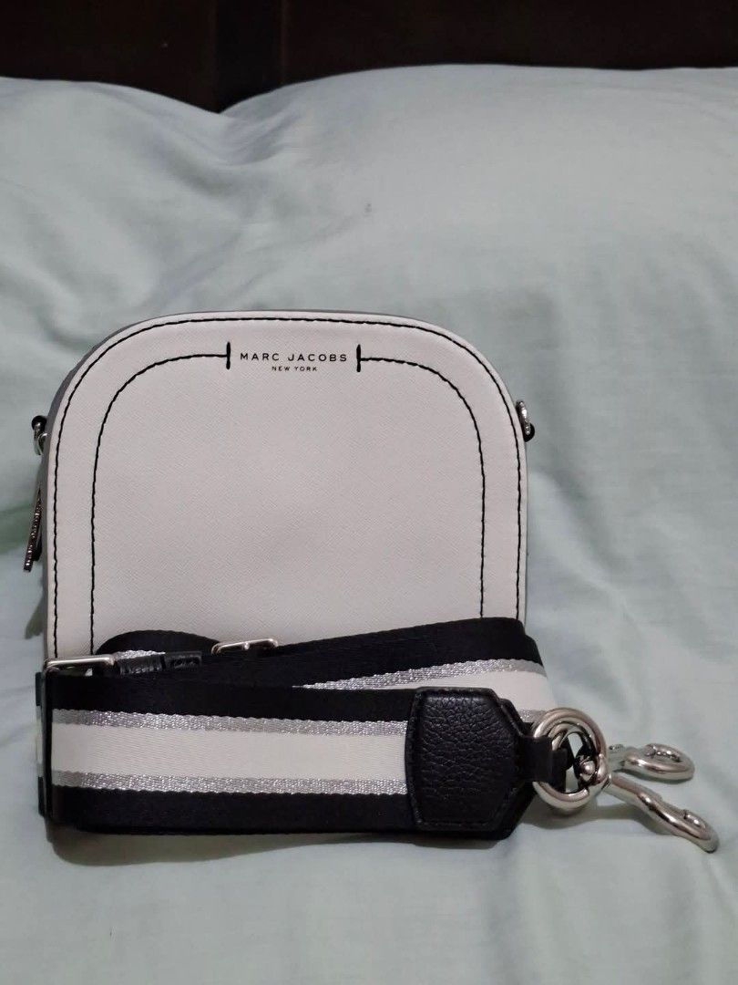 Marc Jacobs The Snapshot Camera Bag White Black (Category: Luxury Bags & Wallets) located in Manila. Submitted by closetprincess (Listing ID 1468958758, Image 3). Description: - Authentic Marc Jacobs camera bag in pristine white and grey leather - Stylish black and white striped web strap with silver accents (detachable and adjustable) - Secure dual zip closure with grey side panels - Features an internal slip pocket with brand label tag and fron