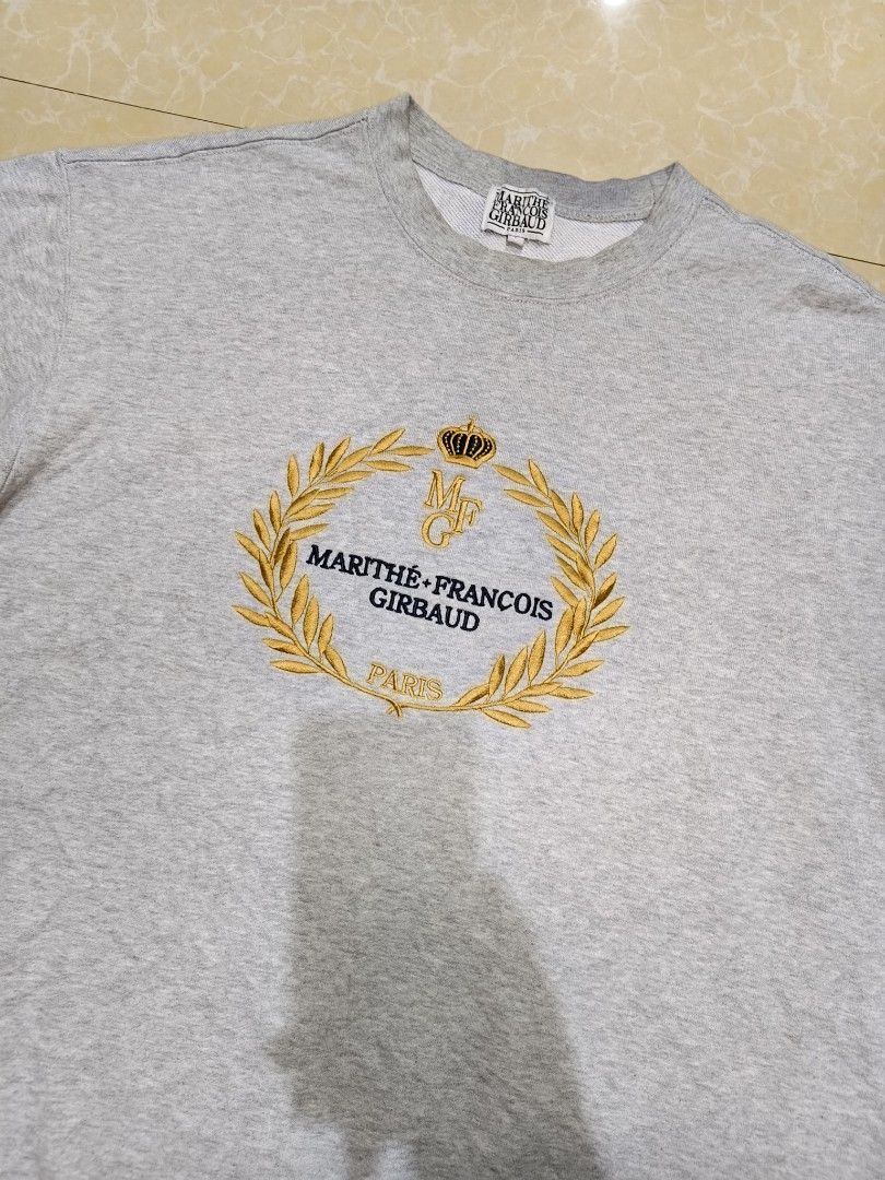 Marithe Francois Girbaud Grey Sweatshirt Size L (Category: Coats, Jackets and Outerwear) located in Manila. Submitted by purefire-477a (Listing ID 1469078263, Image 3). Description: - Brand: Marithe Francois Girbaud - Style: Crewneck sweatshirt - Color: Grey - Size: Large (Relaxed fit) - Measurements: 23 inches width x 26 inches length - Details: Vibrant gold and navy chest embroidery with laurel wreath and crown graphic - Material: Soft cotton b