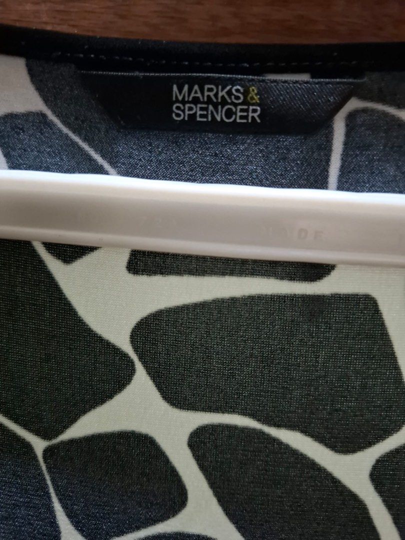 Marks & Spencer Black and White Patterned Tunic Blouse (Category: Blouses) located in Muntinlupa City. Submitted by everythingmustgo_8475da (Listing ID 1469013365, Image 2). Description: - Brand: Marks & Spencer - Design: Striking black & white geometric animal print - Neckline & Details: Stylish V-neck with solid black trim on collar and cuffs - Sleeves: Three-quarter length - Fit: Comfortable and flowy - Versatility: Ideal for casual outings or