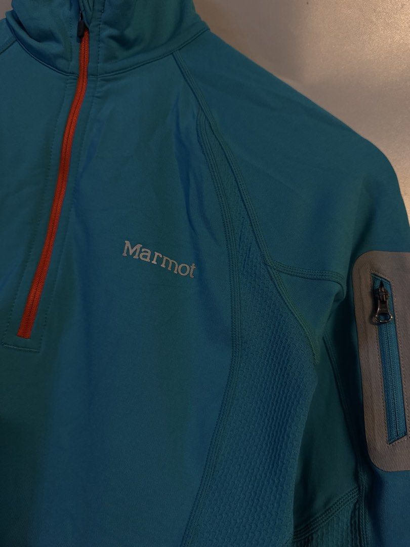 Marmot 1/4 Zip Athletic Jacket Blue Size XS (Category: Coats, Jackets and Outerwear) located in Alaminos. Submitted by outfitcheck.ph (Listing ID 1469101752, Image 2). Description: - Brand: Marmot - Size: XS - Color: Bright blue with striking orange zipper teeth - Design: Quarter-zip front with a convenient small sleeve pocket on the left arm - Breathability: Mesh panels along the sides and back to keep you cool - Safety: Reflective dots along th
