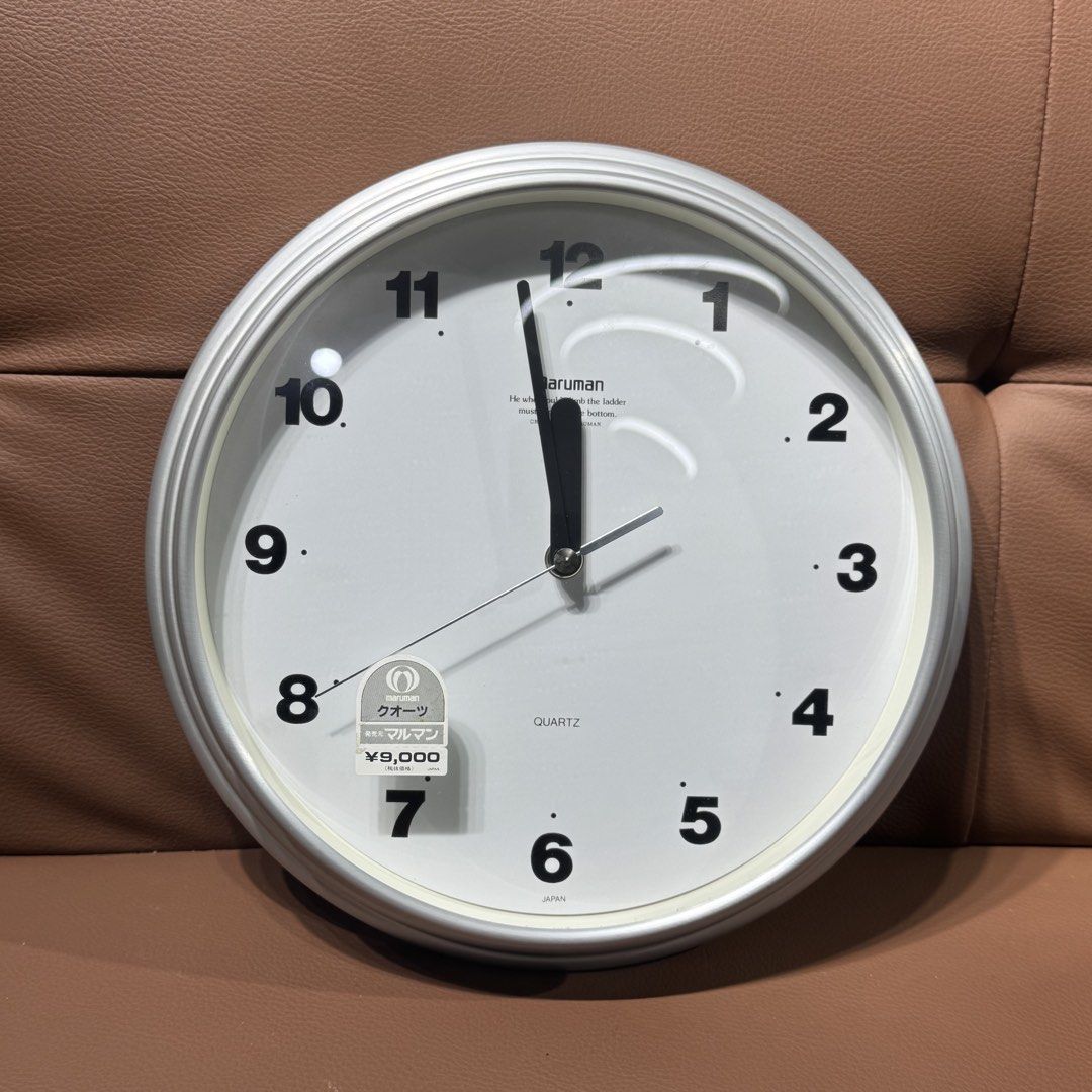 Maruman Quartz Wall Clock UM-27211 Silver (Category: Clocks) located in Rizal. Submitted by houseofbell (Listing ID 1469156660, Image 1). Description: - Brand: Maruman (Model UM-27211) - Design: Silver aluminum frame with clean white face and bold black numbers - Movement: Sweep second hand (silent and smooth) - Condition: Clean, like-new with original box and 9,000 yen price tag still attached - Power: Runs on 1 battery (included) - Perfect for 
