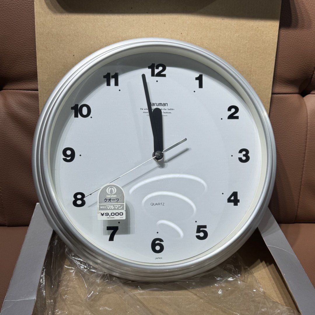 Maruman Quartz Wall Clock UM-27211 Silver (Category: Clocks) located in Rizal. Submitted by houseofbell (Listing ID 1469156660, Image 3). Description: - Brand: Maruman (Model UM-27211) - Design: Silver aluminum frame with clean white face and bold black numbers - Movement: Sweep second hand (silent and smooth) - Condition: Clean, like-new with original box and 9,000 yen price tag still attached - Power: Runs on 1 battery (included) - Perfect for 