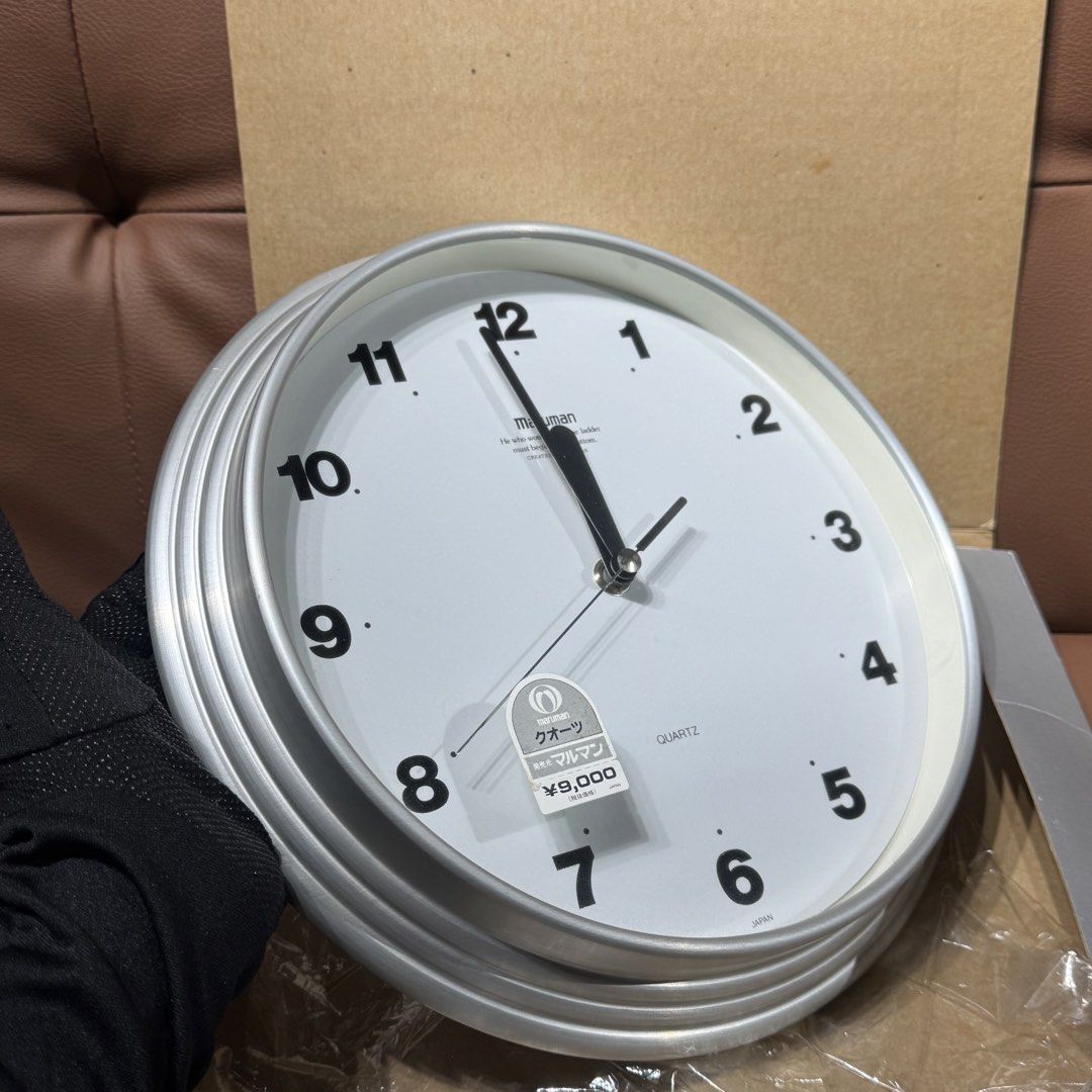 Maruman Quartz Wall Clock UM-27211 Silver (Category: Clocks) located in Rizal. Submitted by houseofbell (Listing ID 1469156660, Image 2). Description: - Brand: Maruman (Model UM-27211) - Design: Silver aluminum frame with clean white face and bold black numbers - Movement: Sweep second hand (silent and smooth) - Condition: Clean, like-new with original box and 9,000 yen price tag still attached - Power: Runs on 1 battery (included) - Perfect for 