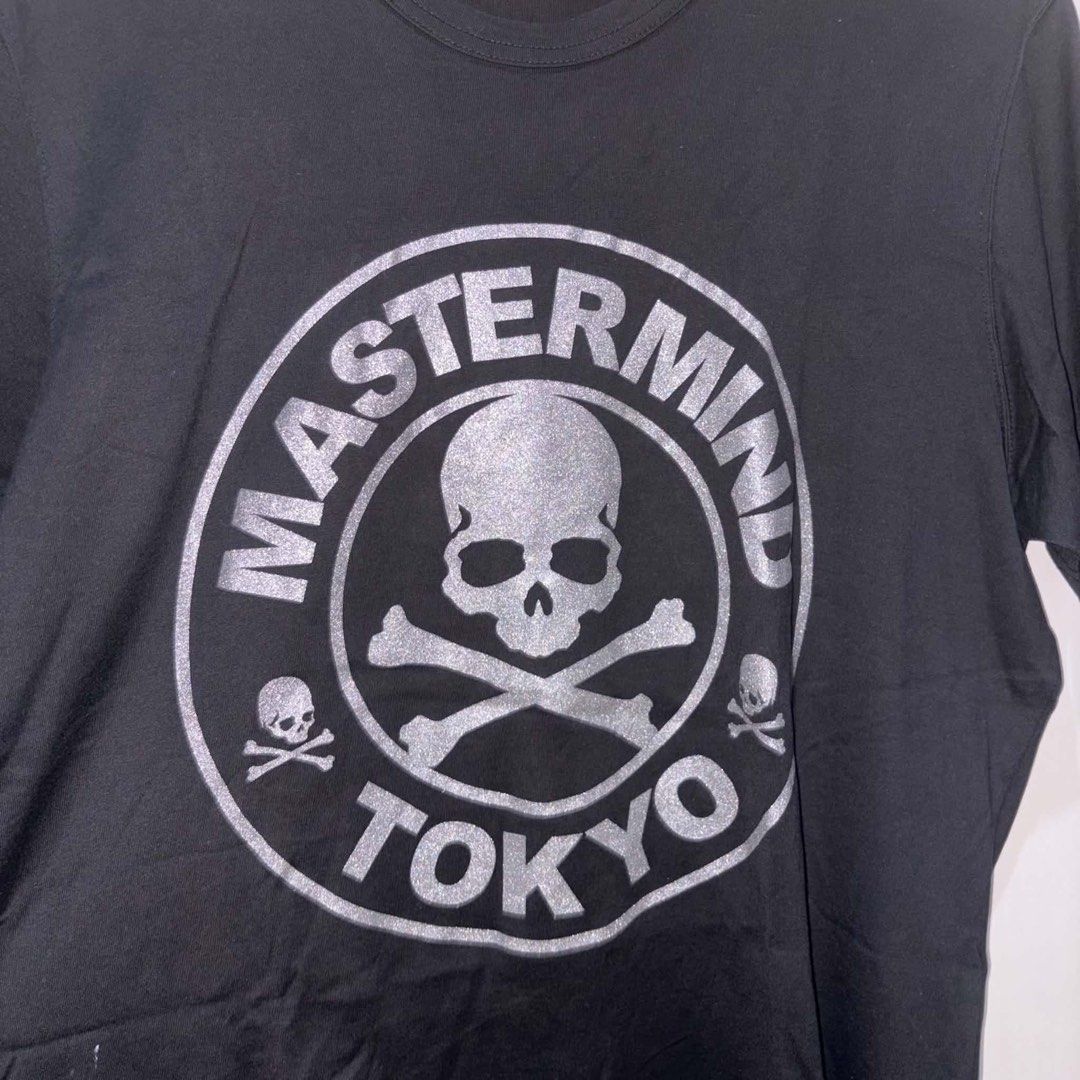 Mastermind Japan Tokyo (Category: Tshirts & Polo Shirts ) located in Rosario. Submitted by elyukano2506 (Listing ID 1469018428, Image 3). Description: - Brand: Mastermind Japan - Color: Black - Size: Large (L) - Material: 100% Cotton with standard care tags intact - Design: Large silver glitter skull graphic in a circular logo on the front - Back Details: Smaller Mastermind Tokyo branding and skull graphics across the upper back - Fit: Classic sh