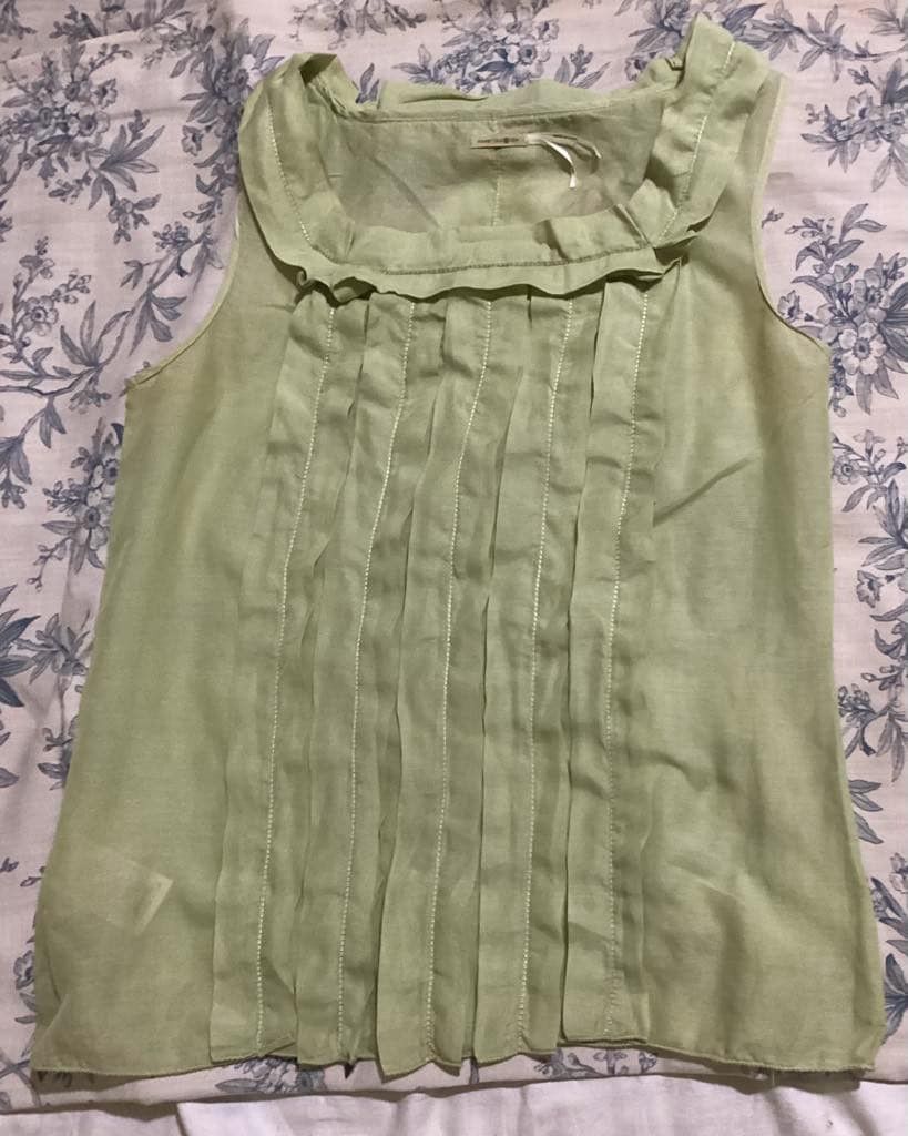 Max Studio Pleated Sleeveless Top Green (Category: Sleeveless) located in Paranaque City. Submitted by calm_youngstore7 (Listing ID 1469042886, Image 2). Description: - Brand: Max Studio - Condition: Brand new with tags (in original plastic packaging) - Color: Pastel green - Design: Sleeveless, vertical pleating on the front, round neckline with ruffles - Fabric: Lightweight and slightly sheer - Freebie: Includes a small Happy Smile hand mirror.