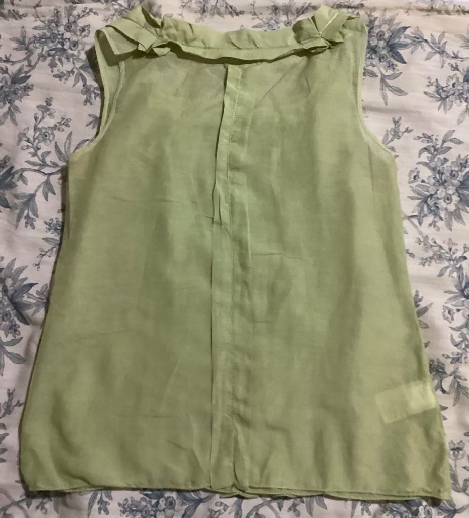 Max Studio Pleated Sleeveless Top Green (Category: Sleeveless) located in Paranaque City. Submitted by calm_youngstore7 (Listing ID 1469042886, Image 3). Description: - Brand: Max Studio - Condition: Brand new with tags (in original plastic packaging) - Color: Pastel green - Design: Sleeveless, vertical pleating on the front, round neckline with ruffles - Fabric: Lightweight and slightly sheer - Freebie: Includes a small Happy Smile hand mirror.