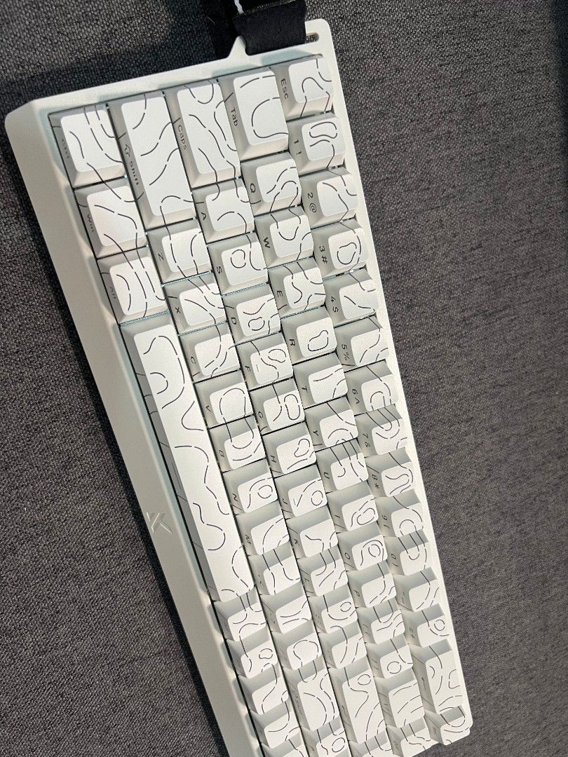 MCHOSE ACE 68 Magnetic Switch Keyboard (Category: Computer Keyboard) located in Manila. Submitted by _frncis (Listing ID 1469136717, Image 2). Description: - Model: MCHOSE ACE 68 magnetic switch keyboard - Color/Design: Clean white with a unique topographic keycap pattern - Features: Compact layout with a stylish left-side carry strap - Gaming Performance: Equipped with rapid trigger switches and customizable actuation - Inclusions: Original box 