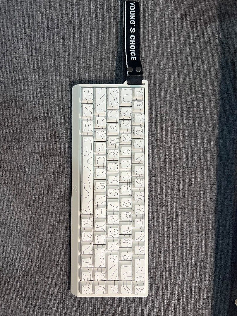 MCHOSE ACE 68 Magnetic Switch Keyboard (Category: Computer Keyboard) located in Manila. Submitted by _frncis (Listing ID 1469136717, Image 3). Description: - Model: MCHOSE ACE 68 magnetic switch keyboard - Color/Design: Clean white with a unique topographic keycap pattern - Features: Compact layout with a stylish left-side carry strap - Gaming Performance: Equipped with rapid trigger switches and customizable actuation - Inclusions: Original box 