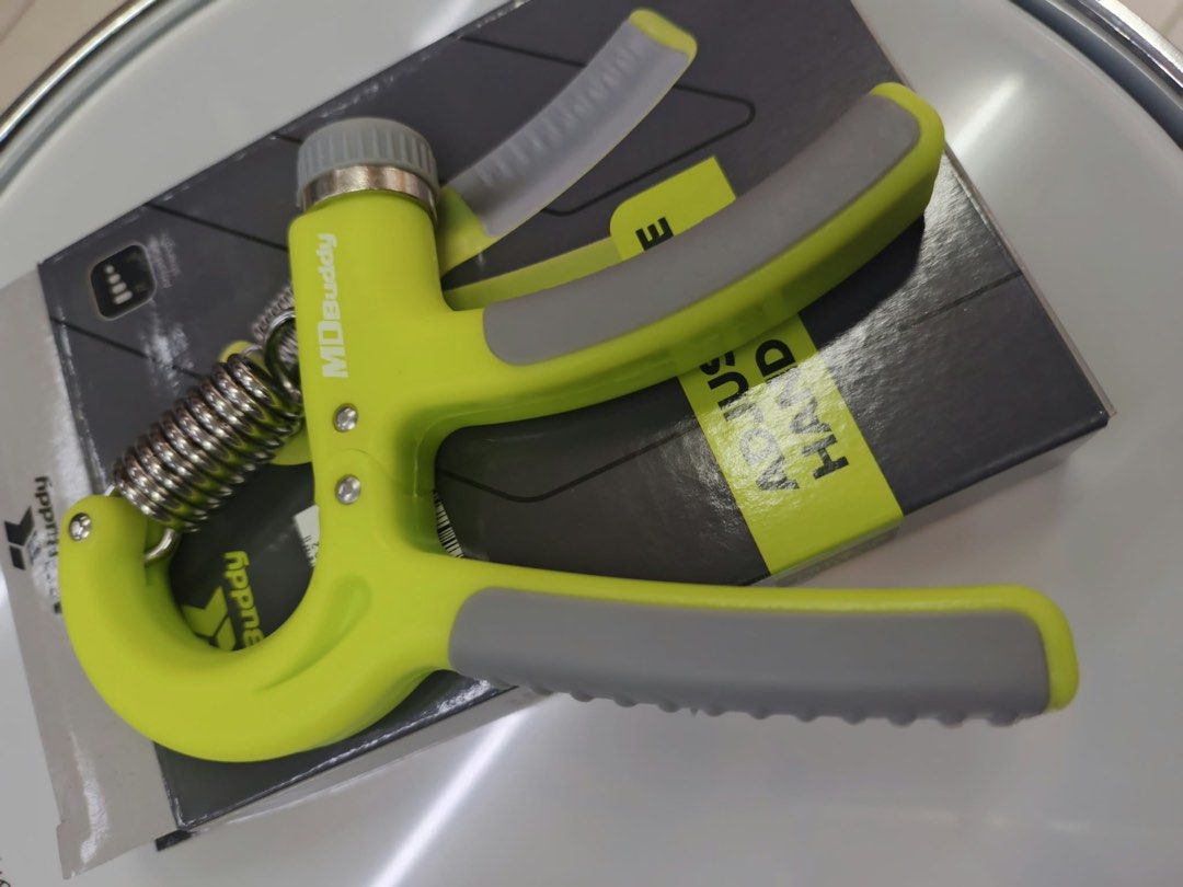 MD Buddy Adjustable Hand Grip Strengthener (Category: Weights & Dumbbells) located in Las Pinas. Submitted by andreadomingo2518 (Listing ID 1469008428, Image 3). Description: - Brand: MD Buddy - Item: Adjustable hand grip strengthener - Color: Lime green and grey - Resistance: Adjustable via twist dial with heavy-duty steel spring - Comfort: Textured rubber handles for a solid, secure grip - Inclusions: Comes with original box - Condition: Excell