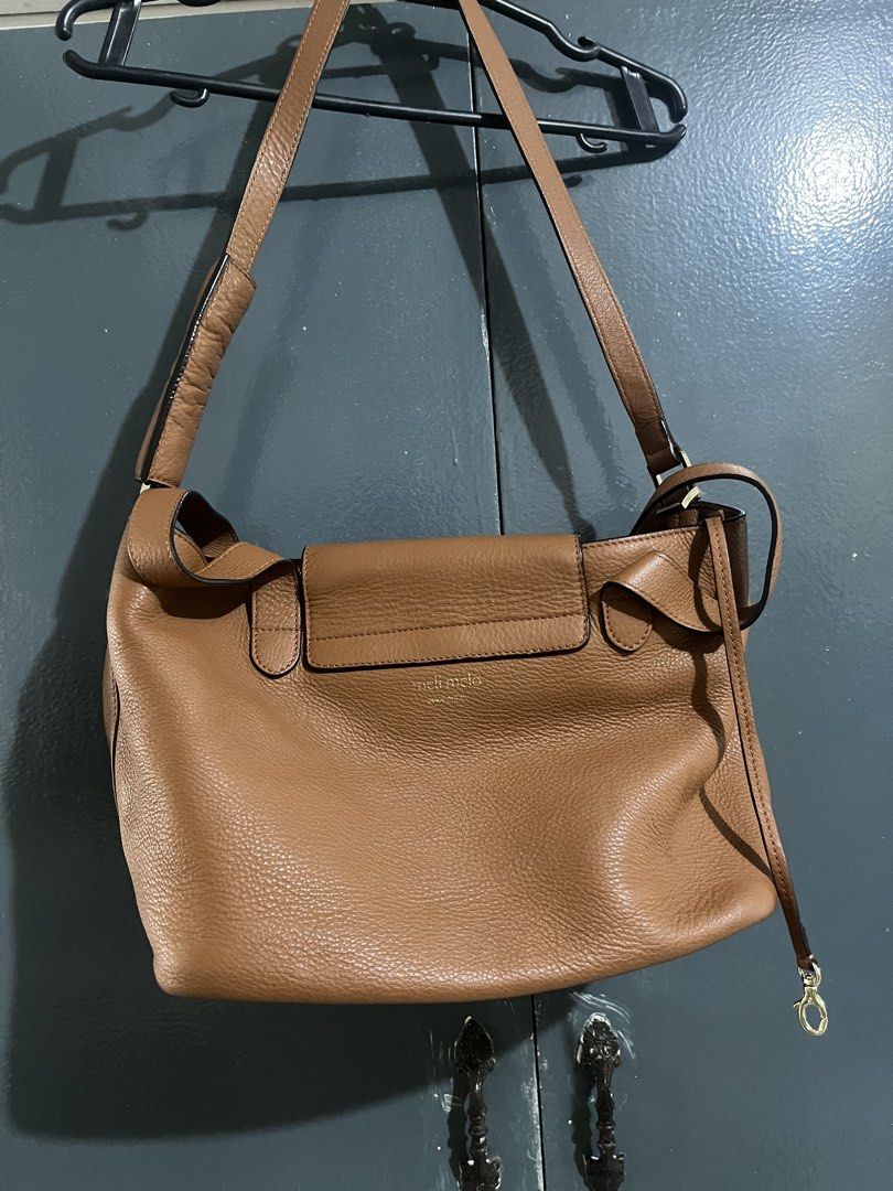 Meli Melo Tan Leather Shoulder Bag (Category: Luxury Bags & Wallets) located in Las Pinas. Submitted by freeowl_eb0f7b (Listing ID 1468936443, Image 2). Description: - Authentic Meli Melo leather handbag in a versatile tan earth tone - Structured design with a chic front flap closure and gold-tone hardware - Features sturdy top handles and a convenient adjustable shoulder strap - Premium grainy leather texture with subtle branding stamped on the 