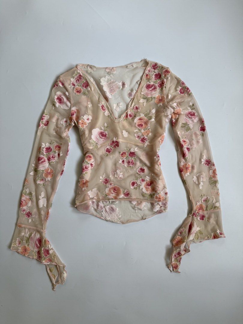 Mesh Floral Long Sleeve V-Neck Blouse (Category: Longsleeves) located in Tarlac. Submitted by kr_closet (Listing ID 1468934491, Image 2). Description: - Style: Y2K / Cottagecore aesthetic - Design: Pink floral print all over with a V-neckline - Sleeves: Long flared sleeves with cute lettuce trim - Fit: Gathered waist detail for a flattering silhouette - Fabric: Lightweight and slightly sheer mesh.