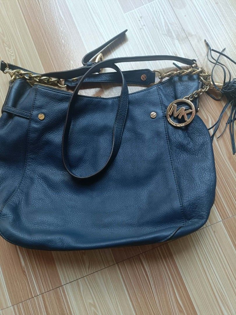 Michael Kors Dark Blue Leather Shoulder Bag (Category: Luxury Bags & Wallets) located in Imus. Submitted by boosterph691 (Listing ID 1468955030, Image 1). Description: - Brand: Michael Kors - Color: Dark Blue with Gold-tone hardware - Material: Premium Leather - Features: Round MK logo charm, chain-link strap detail, trendy fringe tassel - Closure: Secure top zipper closure - Interior: Spacious main compartment for your daily essentials - Conditi