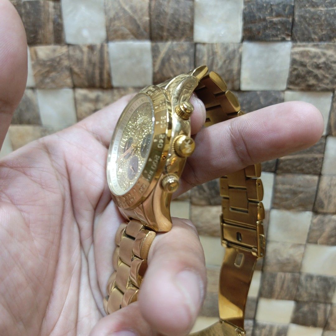 Michael Kors Gold Chronograph Watch MK-6830 (Category: Women's Watches) located in Manila. Submitted by narju1234 (Listing ID 1468998807, Image 2). Description: - Brand: Michael Kors - Model: MK-6830 - Design: Sparkling gold dial with 3 contrasting black sub-dials and chronograph pushers - Material: Gold-tone stainless steel bracelet with a secure folding clasp - Condition: Pre-loved with standard wear marks on the case and bracelet from previous
