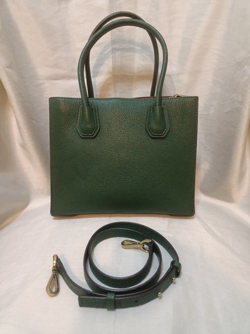 Michael Kors Green Leather Tote Bag (Category: Luxury Bags & Wallets) located in Manila. Submitted by preloved439 (Listing ID 1468992170, Image 2). Description: - Authentic Michael Kors Mercer - Material: Premium deep green pebbled leather - Hardware: Elegant gold-tone with front padlock charm - Versatility: Double top handles and detachable, adjustable shoulder strap - Design: Structured side panels with protective metal feet on the bottom - Con