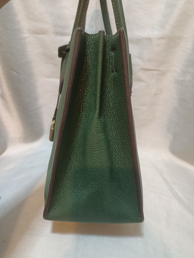 Michael Kors Green Leather Tote Bag (Category: Luxury Bags & Wallets) located in Manila. Submitted by preloved439 (Listing ID 1468992170, Image 3). Description: - Authentic Michael Kors Mercer - Material: Premium deep green pebbled leather - Hardware: Elegant gold-tone with front padlock charm - Versatility: Double top handles and detachable, adjustable shoulder strap - Design: Structured side panels with protective metal feet on the bottom - Con