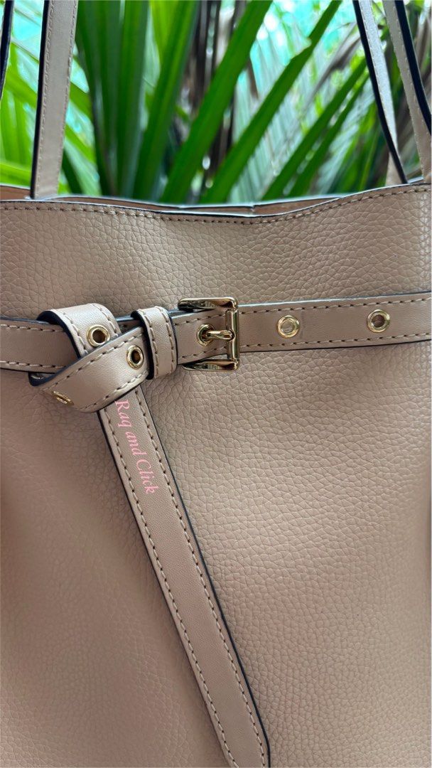 Michael Kors Pebble Leather Tote Bag Beige (Category: Luxury Bags & Wallets) located in Quezon. Submitted by mommynizooeyatichiro (Listing ID 1468979697, Image 2). Description: - Brand: Michael Kors - Material: Soft beige pebble leather - Hardware: Premium gold-tone with front logo lettering - Design: Adjustable side belt accent and structured flat bottom that holds its shape - Straps: Double shoulder straps with clean edges - Closure: Roomy main