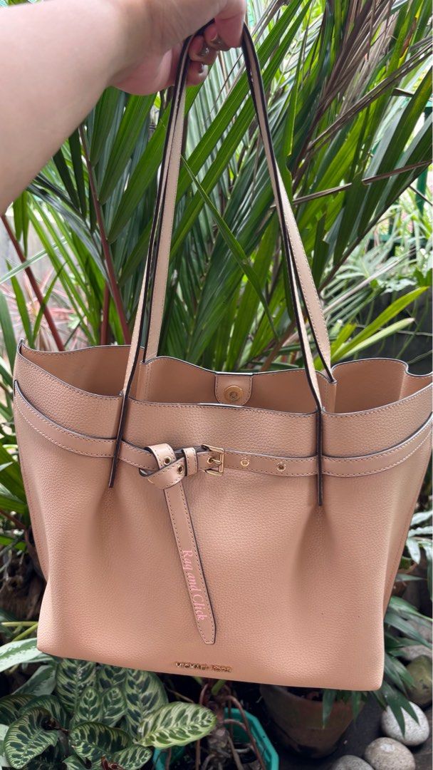 Michael Kors Pebble Leather Tote Bag Beige (Category: Luxury Bags & Wallets) located in Quezon. Submitted by mommynizooeyatichiro (Listing ID 1468979697, Image 1). Description: - Brand: Michael Kors - Material: Soft beige pebble leather - Hardware: Premium gold-tone with front logo lettering - Design: Adjustable side belt accent and structured flat bottom that holds its shape - Straps: Double shoulder straps with clean edges - Closure: Roomy main