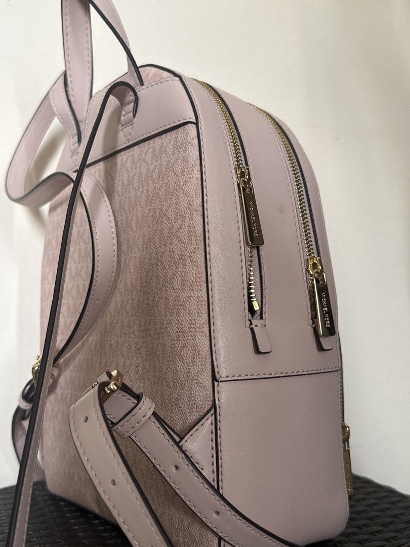 Michael Kors Pink MK Monogram Backpack (Category: Backpacks) located in Quezon City. Submitted by siasmittens (Listing ID 1468944501, Image 2). Description: - Brand: Michael Kors - Color: Soft pink with signature MK monogram and solid leather trim - Hardware: Premium gold-tone with engraved zipper pulls - Compartment: Dual-zip main compartment for secure storage - Straps: Adjustable shoulder straps and convenient top carry handle - used once -rsf