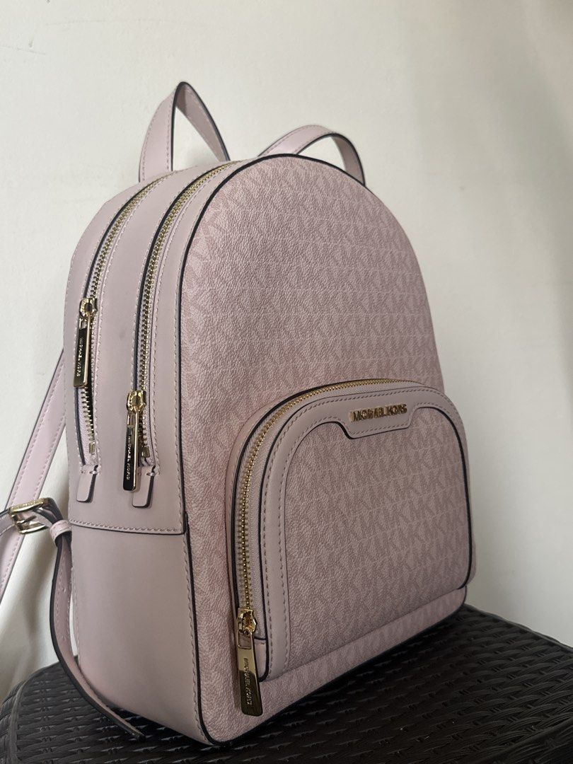 Michael Kors Pink MK Monogram Backpack (Category: Backpacks) located in Quezon City. Submitted by siasmittens (Listing ID 1468944501, Image 3). Description: - Brand: Michael Kors - Color: Soft pink with signature MK monogram and solid leather trim - Hardware: Premium gold-tone with engraved zipper pulls - Compartment: Dual-zip main compartment for secure storage - Straps: Adjustable shoulder straps and convenient top carry handle - used once -rsf