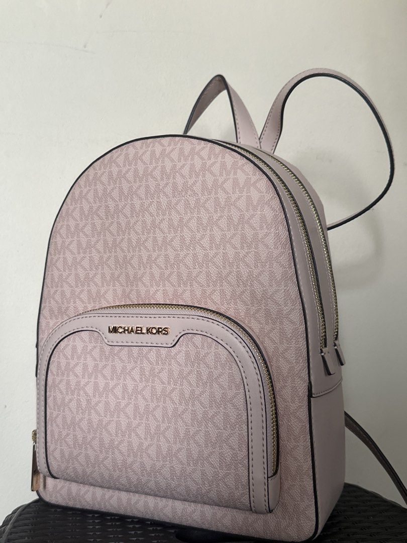 Michael Kors Pink MK Monogram Backpack (Category: Backpacks) located in Quezon City. Submitted by siasmittens (Listing ID 1468944501, Image 1). Description: - Brand: Michael Kors - Color: Soft pink with signature MK monogram and solid leather trim - Hardware: Premium gold-tone with engraved zipper pulls - Compartment: Dual-zip main compartment for secure storage - Straps: Adjustable shoulder straps and convenient top carry handle - used once -rsf