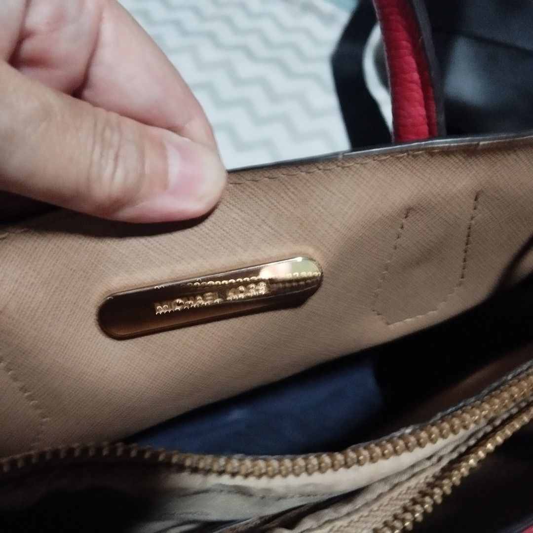 Michael Kors Red Leather Tote Bag With Strap (Category: Cross-body Bags) located in Manila. Submitted by lene48 (Listing ID 1469011645, Image 1). Description: - Authentic Michael Kors bright red handbag in luxurious pebbled leather - Elegant gold-tone hardware and secure top zipper closure - Versatile carry options with double top handles and a detachable shoulder strap - Fabric-lined interior featuring the signature metal brand plaque - Protecti