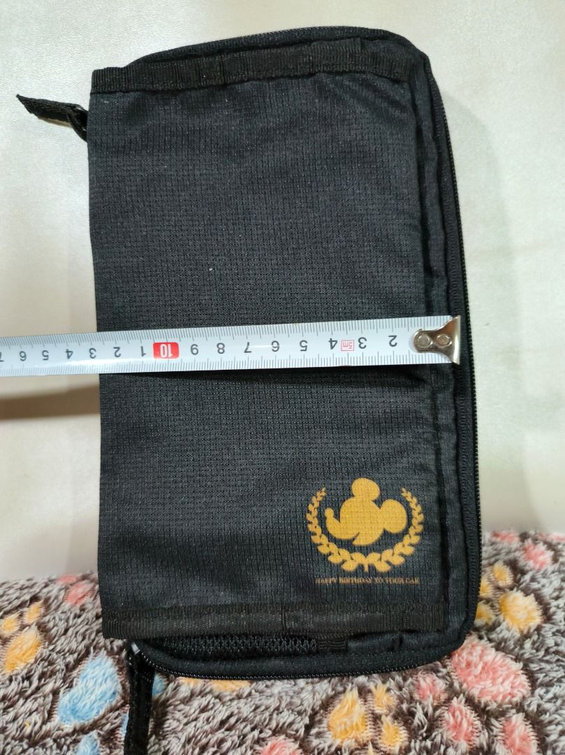 Mickey Mouse Black Organizer Pouch (Category: Purses & Pouches) located in San Leonardo. Submitted by burgossanleonardo.12345 (Listing ID 1469082338, Image 3). Description: - Stylish black multi-compartment pouch with gold Mickey Mouse silhouette logo - Compact size measuring approximately 21 cm x 12 cm - Organized interior with clear plastic pockets, zippered compartments, and mesh slots - Convenient elastic holders ideal for cards, stationery, 