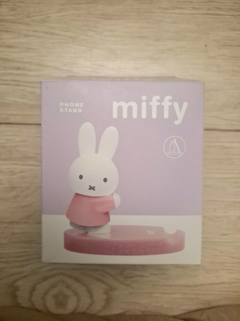 Miffy Phone Stand Purple (Category: Mounts & Holders) located in Tanza. Submitted by jajangmyeonnn (Listing ID 1468940185, Image 2). Description: - Bought in Vietnam - Authentic Miffy phone stand in a gorgeous purple colorway - Features an adorable figurine design holding the circular base - Great desk accessory for holding smartphones both vertically and horizontally - Brand new and unopened, kept securely inside its original printed box - Inclu