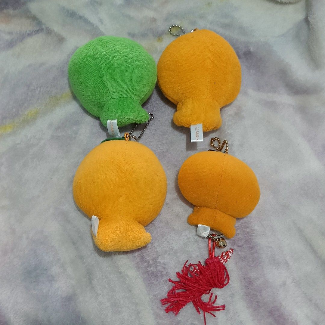 Mikan Bouya San-X plush keychains (Category: Plushies & Soft Toys) located in Baguio. Submitted by baileybails (Listing ID 1468963166, Image 2). Description: - Set of 4 authentic San-X plush keychains - Includes 1 green fruit character and 3 orange characters - Soft and huggable fabric material - Features secure ball chains and original San-X tag labels - Bonus: One orange keychain comes with a red and white tassel charm and a working bell - Clea
