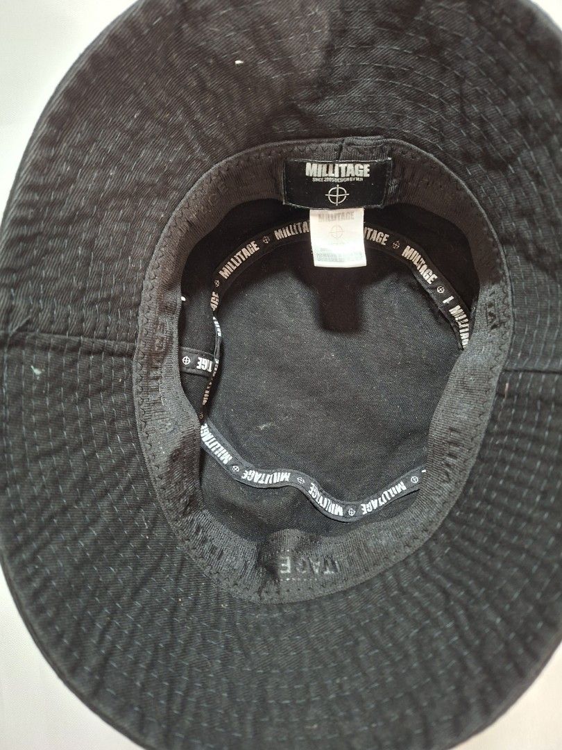 Millitage Black Bucket Hat (Category: Caps & Hats) located in Baguio. Submitted by restyrille77846 (Listing ID 1469066442, Image 2). Description: - Brand: Millitage - Color: Classic Black - Style: Casual streetwear bucket hat - Material: 100% Cotton for comfort - Details: Inner taped seams with branded text pattern and woven label inside - Fit: Standard fit, easy to pair with any casual outfit - Condition: Brand new / Excellent.