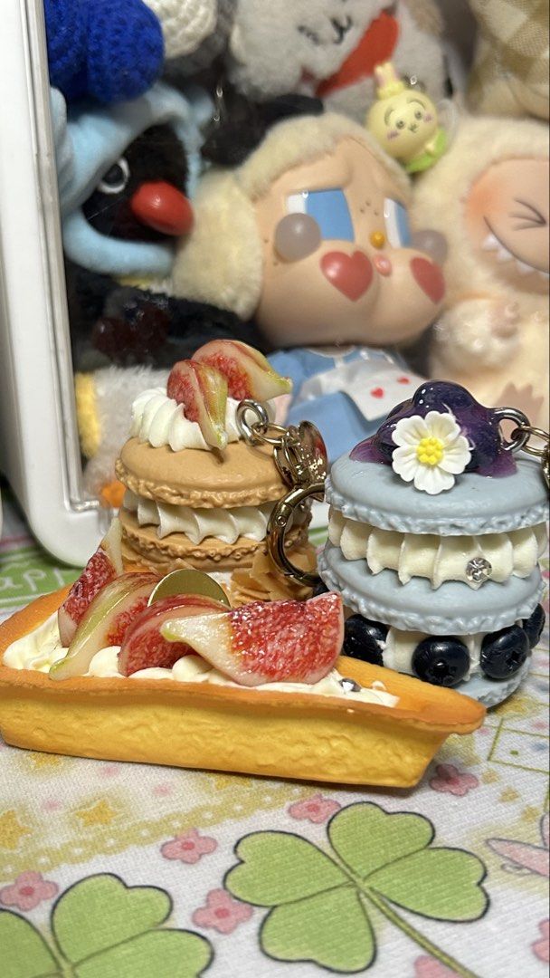 Miniature Dessert Pastry Macaron and Tart Keychains (Category: Charms) located in Manila. Submitted by yume_artsss (Listing ID 1468975257, Image 1). Description: - 200 each for the macaroons and 150 for the tart, take all for only 450 set -Adorable miniature food keychain set - Includes: 1 fig macaron, 1 fig tart slice, and 1 blueberry macaron with a cute white flower detail - Features detailed fake cream and realistic fruit toppings - Equipped w