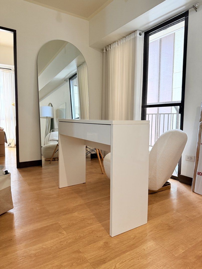 Minimalist White Study Desk with Drawer (Category: Tables & Sets) located in Taguig. Submitted by boxedgoodies (Listing ID 1469157291, Image 2). Description: - Minimalist white desk with a clean, glossy tabletop and wide flat panel legs - Built-in wide pull-out drawer with inner dividers for stationery or makeup - Solid, sturdy structure ideal for modern home offices or study rooms - Condition: Great overall look with one minor scratch near the b