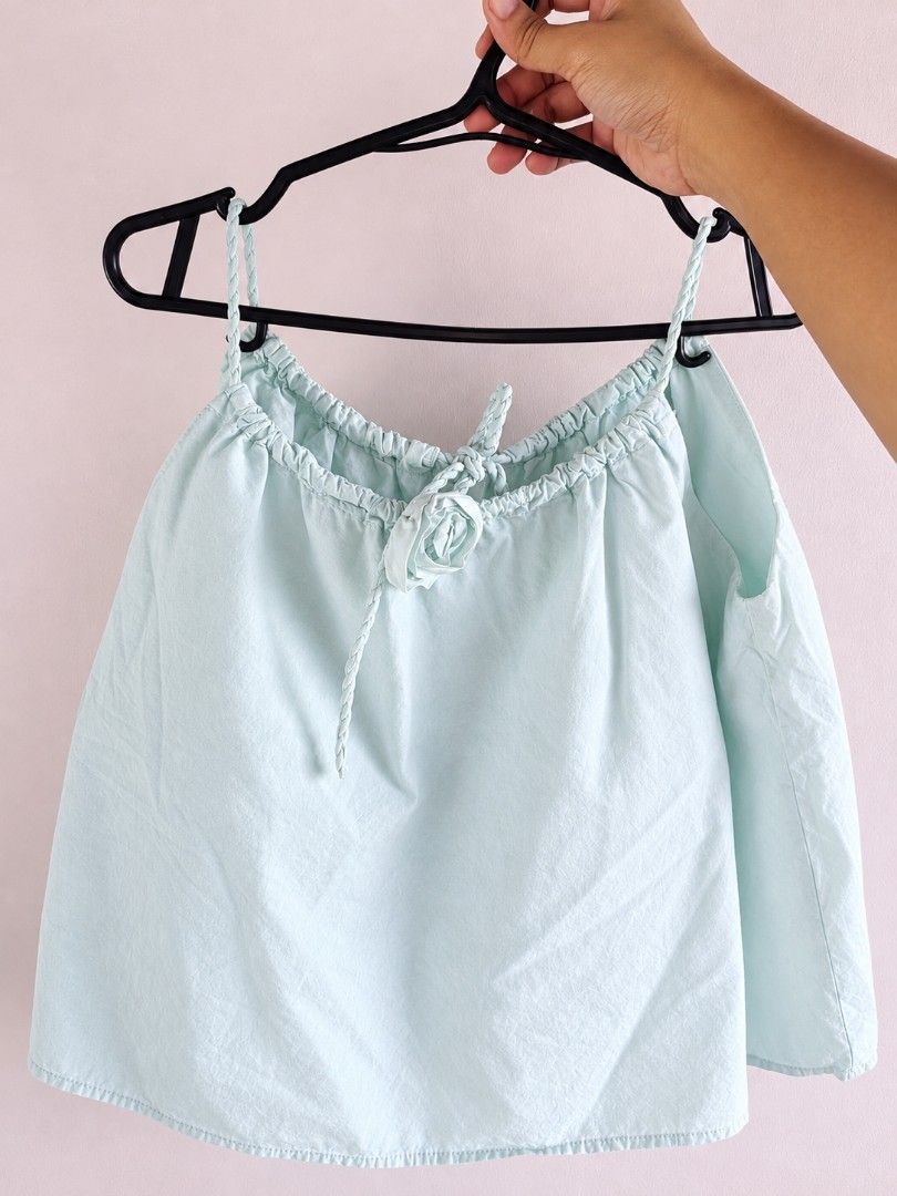 Mint green sleeveless (Category: Sleeveless) located in Taguig. Submitted by iggysclutter (Listing ID 1469029617, Image 1). Description: - Color: Mint Green - Design: Sleeveless with adjustable braided spaghetti straps - Details: fabric rose accent - Fit: Flowy and lightweight - Best for: Summer wear and casual days.
