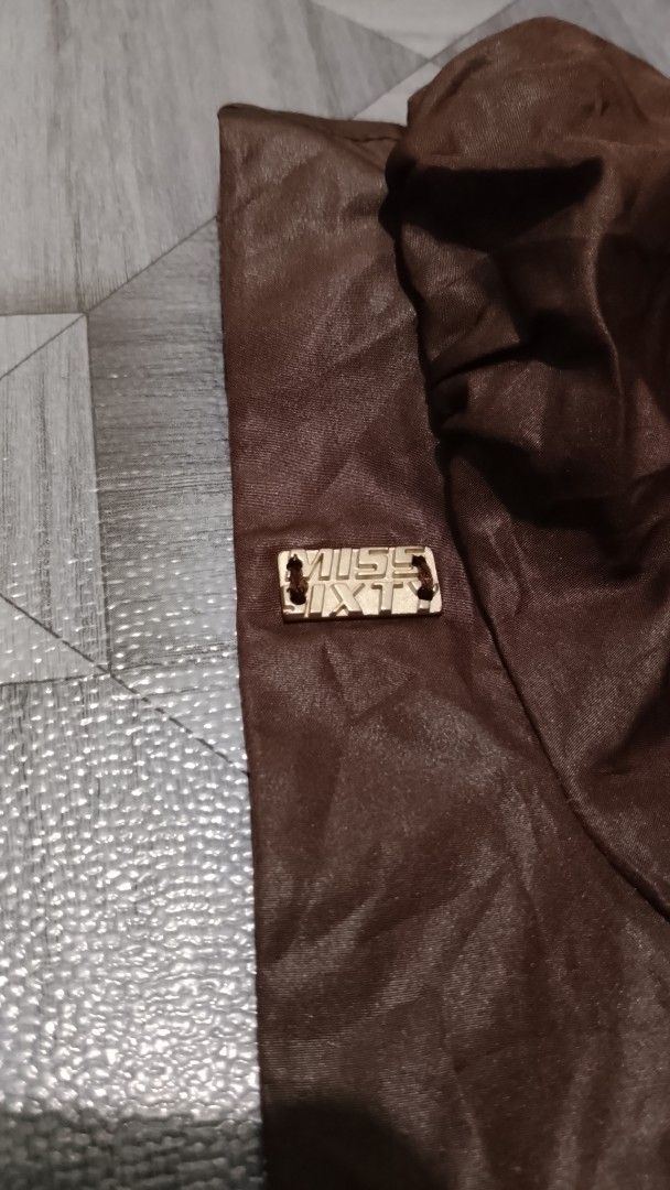 Miss Sixty Brown Blouse Small (Category: Blouses) located in Morong. Submitted by sanjuancla56319 (Listing ID 1468972519, Image 3). Description: - Brand: Miss Sixty - Size: Small - Material: 100% polyester - Color: Brown - Design: Gathered bubble hem, cap sleeves with subtle ruching - Detail: Branded metal logo tag on the right strap - Origin: Made in India - Condition: Clean interior tag with care instructions.