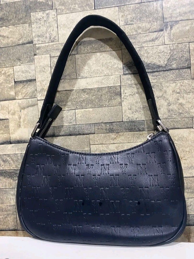 MLB New York Yankees Black Monogram Shoulder Bag (Category: Shoulder Bags) located in Manila. Submitted by tambay_thriftie (Listing ID 1469135520, Image 2). Description: - Brand: MLB (Major League Baseball) - Design: All-over debossed New York Yankees monogram pattern in sleek black - Hardware: Silver-tone NY logo on the front and metal strap accents - Closure: Secure zip top with branded puller - Interior: Clean black lining with official MLB fa