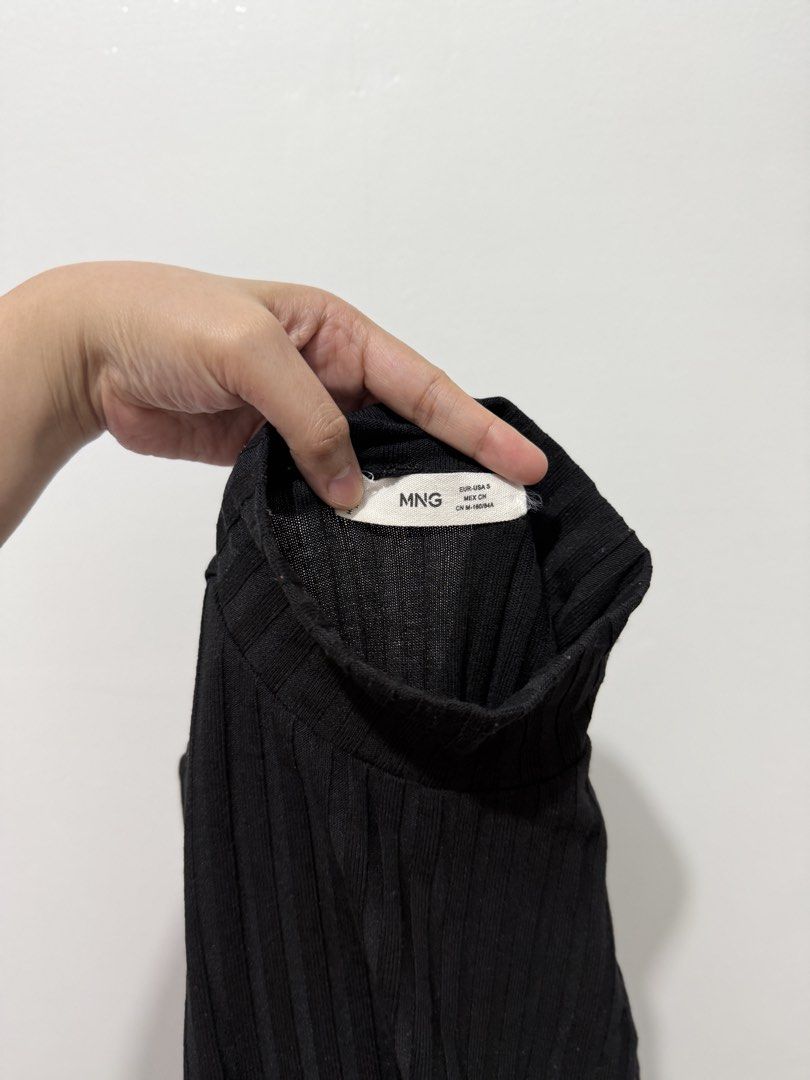 MNG Black Ribbed Mock Neck Top (Category: Longsleeves) located in Rodriguez. Submitted by prelovedbylalaine (Listing ID 1469103198, Image 1). Description: - Brand: Mango - Style: Mock neck, long-sleeve, vertical ribbed texture - Color: Black - Size: EUR-USA S (CN 160/84A) - Condition: Excellent - Perfect for layering or as a standalone basic piece.