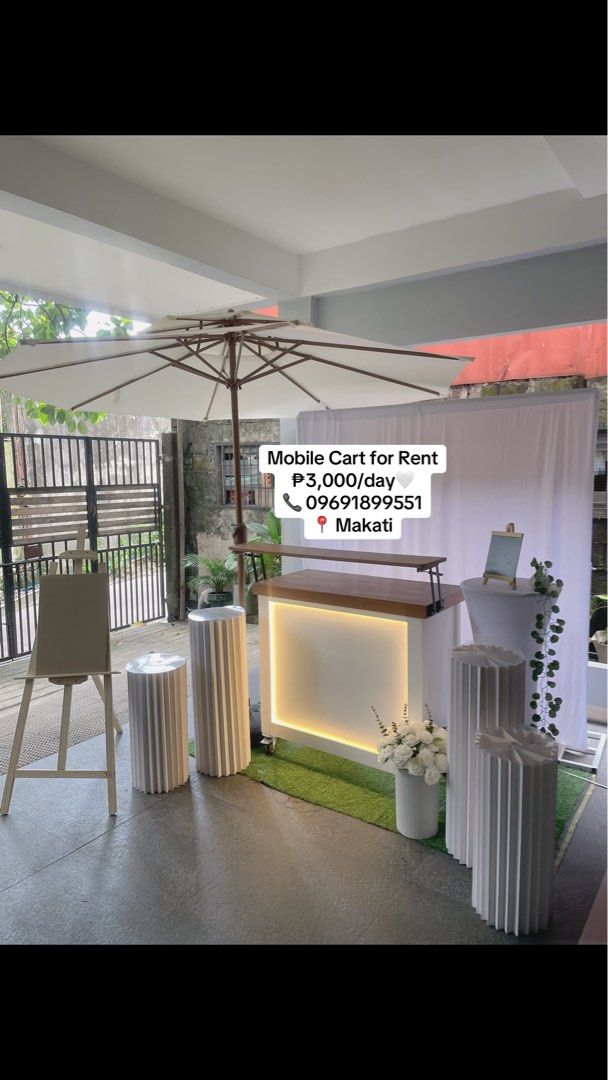 Mobile Cart Set with Umbrella and Display Setup Rental (Category: Outdoor Furniture) located in Makati City. Submitted by tortieandbrewcartrental (Listing ID 1469090578, Image 1). Description: Elevate your event or pop-up shop with our complete mobile cart setup! - Rental Rate: ₱3,000 per day - Location: Makati - Inclusions: - Lighted cart - Large white umbrella - Backdrop stand - Cylindrical display pillars - Easel - Decorative flowers - Contact