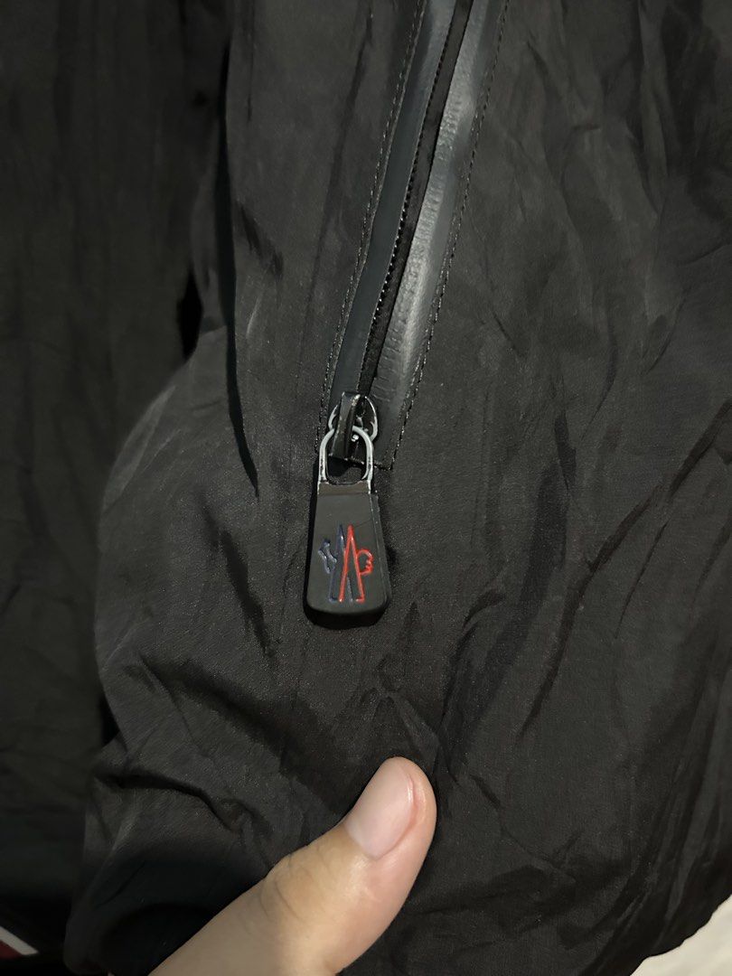 Moncler Black Waterproof Hooded Jacket (Category: Coats, Jackets and Outerwear) located in Barotac Nuevo. Submitted by ehsherjohn27 (Listing ID 1469021003, Image 2). Description: - Multiple front zip pockets for secure storage - Lightweight synthetic material, ideal for outdoor wear - Full zip closure with ribbed cuffs and subtle stripe detail - Signature Moncler interior collar branding and inner lining logo patch - Stylish Moncler lettering on 