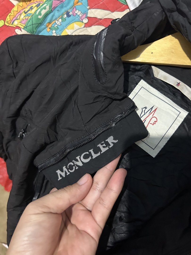Moncler Black Waterproof Hooded Jacket (Category: Coats, Jackets and Outerwear) located in Barotac Nuevo. Submitted by ehsherjohn27 (Listing ID 1469021003, Image 3). Description: - Multiple front zip pockets for secure storage - Lightweight synthetic material, ideal for outdoor wear - Full zip closure with ribbed cuffs and subtle stripe detail - Signature Moncler interior collar branding and inner lining logo patch - Stylish Moncler lettering on 