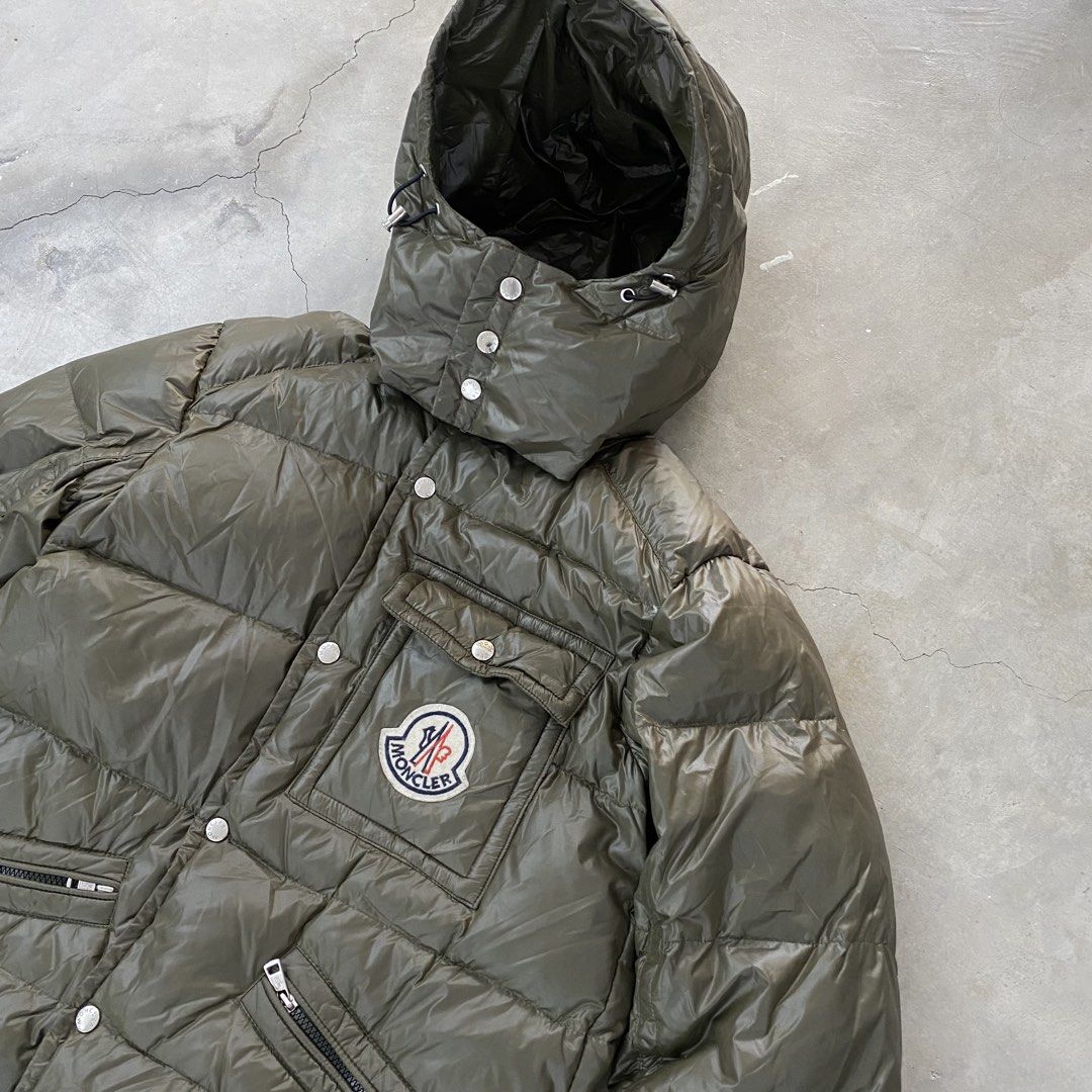 Moncler K2 Puffer Jacket (Category: Luxury Apparel) located in Baliuag. Submitted by n2s01 (Listing ID 1468972060, Image 3). Description: This is a Moncler K2 / Karakorum-style shiny khaki down puffer jacket featuring a detachable hood, snap-button front closure, angled chest/waist pockets, and the iconic Moncler logo patch on the left chest pocket. - No hidden Flaws - Very good condition - Dimes 21 Width 27 Length Dm for more details.