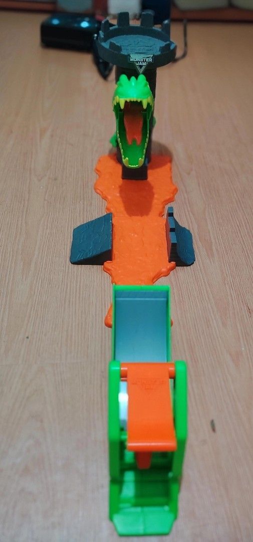 Monster Jam Dragon Launch Play Set (Category: Action & Battle Toys) located in Quezon City. Submitted by lion_s (Listing ID 1469001943, Image 2). Description: - Awesome Monster Jam playset featuring a cool green dragon head design - Includes an orange lava track, ramps, and a built-in launcher for high-flying action - Made with sturdy, durable plastic parts - Perfect gift or addition to any monster truck toy collection.