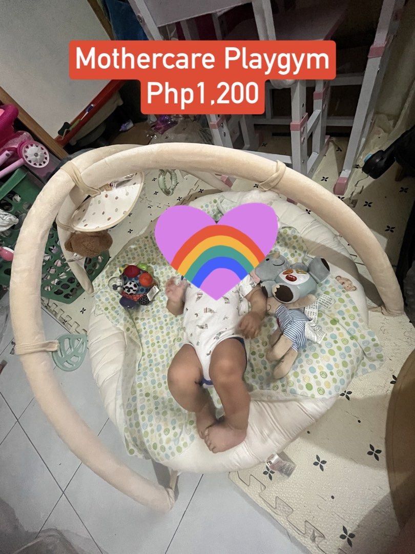 Mothercare Playgym (Category: Infant Playtime) located in Las Pinas. Submitted by freeowl_eb0f7b (Listing ID 1468936939, Image 1). Description: - Brand: Mothercare - Condition: Clean and well-maintained - Design: Soft padded circular base with a cute polka dot pattern - Features: Overhead arches for entertainment during resting or tummy time - Toys included: Plush hanging elephant and colorful rattling ball - Benefit: Safe and comfortable spot fo