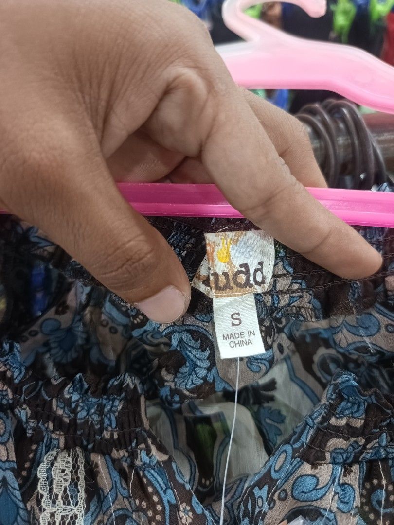 Mudd Boho Paisley Print Off-The-Shoulder Blouse (Category: Blouses) located in Tukuran. Submitted by coyythrift (Listing ID 1469073968, Image 3). Description: - Brand: Mudd (Tag still attached) - Size: Small - Design: Beige with blue, green, and brown paisley pattern - Style: Off-the-shoulder smocked neckline with short puff sleeves - Details: Button-down front with delicate lace trim - Fabric: Lightweight and comfortable.