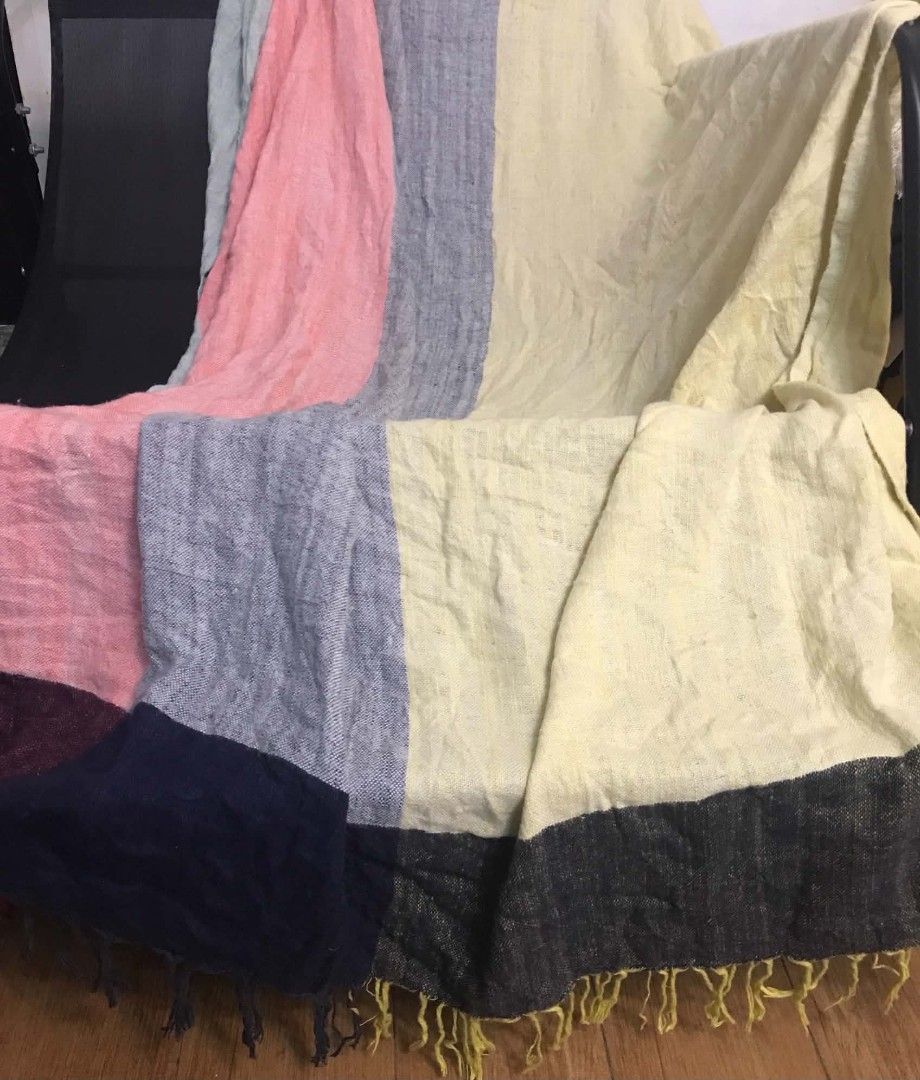 Multicolor Woven Throw Blanket (Category: Bedding & Towels) located in Imus. Submitted by stop_shop7 (Listing ID 1468959418, Image 2). Description: - Multi-colored striped throw blanket with stylish fringe edges - Made in India from a soft cotton and viscose blend - Generous size: 60 x 70 inches - Beautiful, vibrant colors perfect for draping over a sofa or chair - Care instructions: Dry clean only - Flaws: Features a small repair patch and snag 